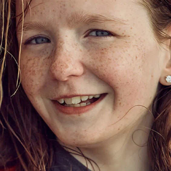 a child smiling at the camera