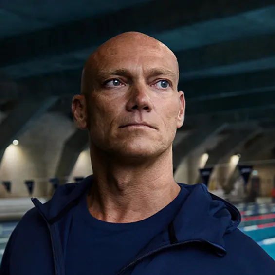 michael klim standing in front of an indoor pool