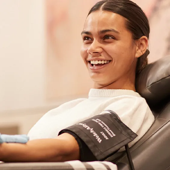 a woman in a donor chair smiling