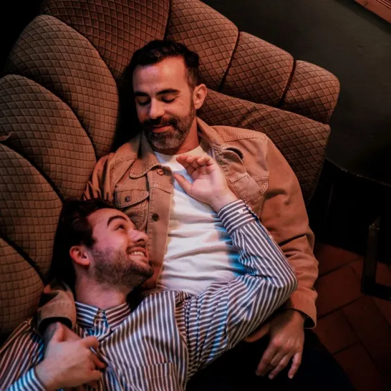 a male couple lying on a couch