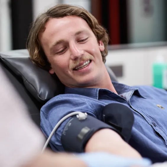 a person in a donor chair having their blood pressure taken