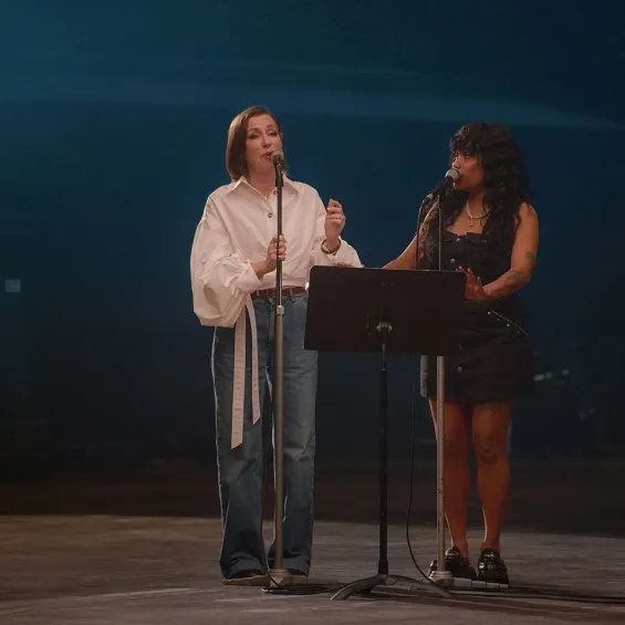 tina arena and ngaiire singing on stage