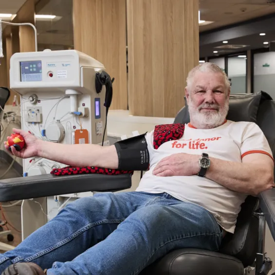 Donor sitting in chair donating plasma