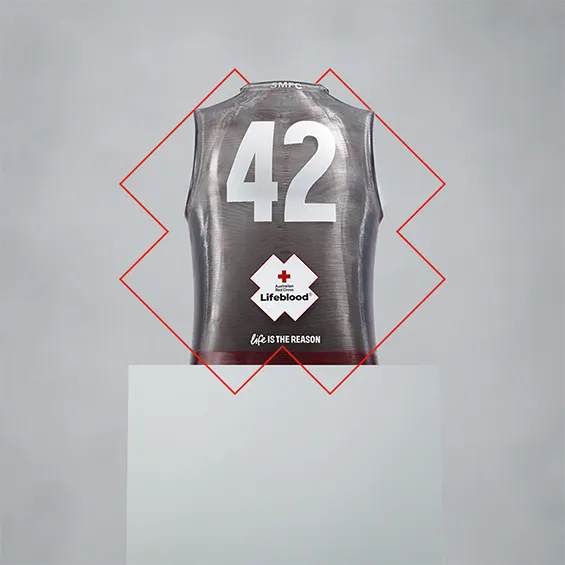 sculpture of a football guernsey with a small amount of red liquid inside with the number 42 and lifeblood logo