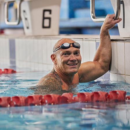 michael klim in a swimming lane smiling at the camera