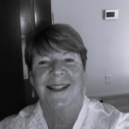 A selfie of a woman with short hair, smiling