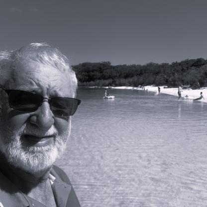 An older man in sunglasses at the beach