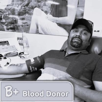 A man on a couch during his donation with a B+ Blood Donor image across the photo