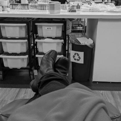 persons legs and feet covered in a blanket while they donate
