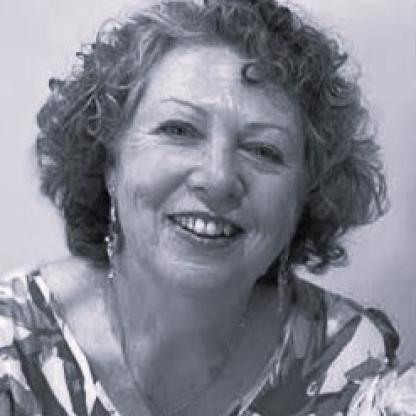 A close up of a woman smiling at the camera