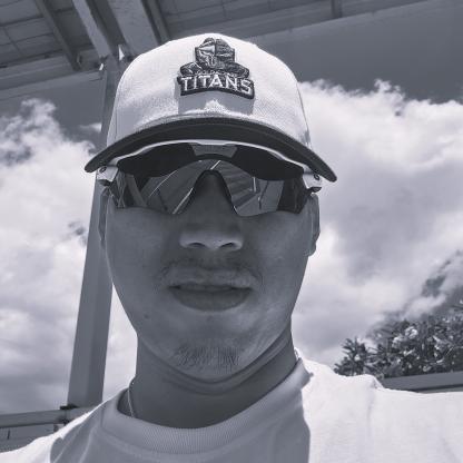 A man wearing a cap and sunglasses