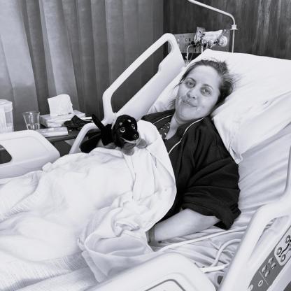 A woman in a hospital bed looking at the camera