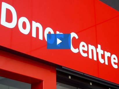a red donor centre entrance with the words donor centre in white text
