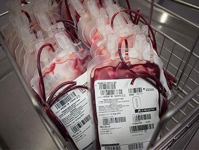 a group of o negative blood packs in a metal basket