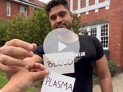 image of a person holding up two cards that say blood and plasma and male choosing the plasma card