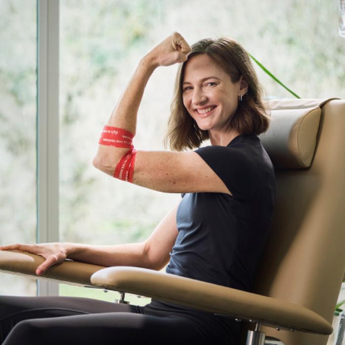 photo of cate campbell in a donor chair smiling to camera