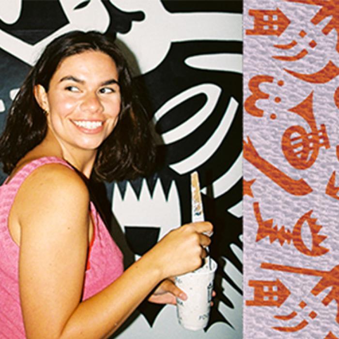 artist aretha brown smiling and holding a paintbrush