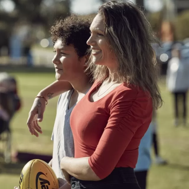 An Anti-D recipient standing in a sports oval