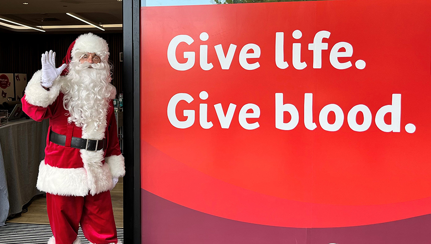 Santa clause in front of Lifeblood sign