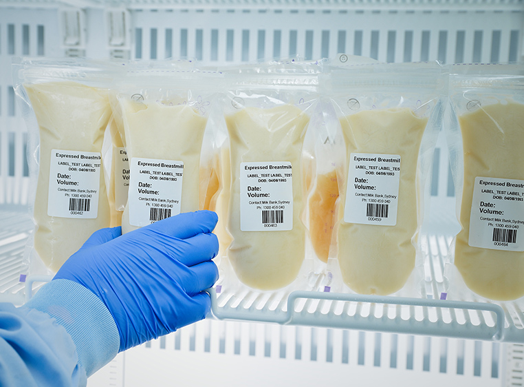 bags of donated human breast milk in fridge