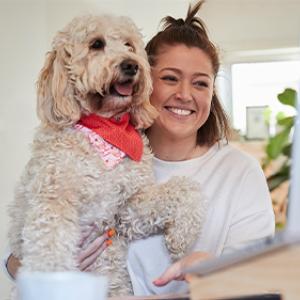 Female Lifeblood employee with her dog working from home